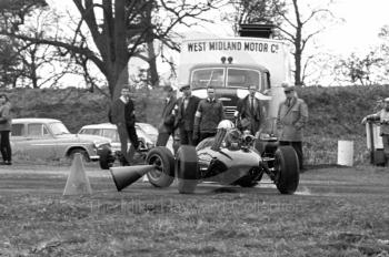 A single seater spins near a West Midlands Motor Company breakdown truck, sixth National Loton Park Speed Hill Climb, April 1965.