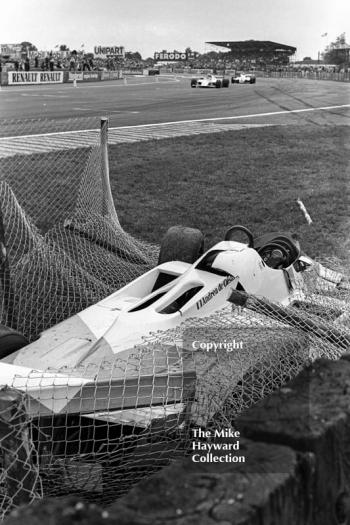 Marlboro McLaren MP4 of Andrea de Cesaris in the catch fencing at Woodcote after crashing on lap 3, Silverstone, British Grand Prix 1981.
