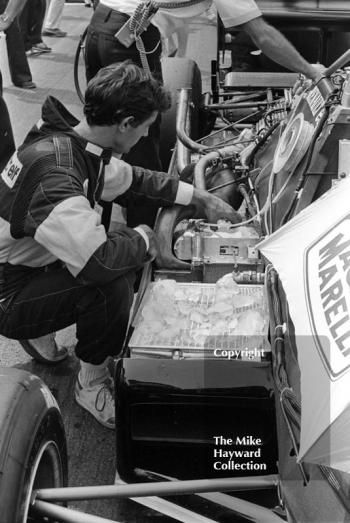 A mechanic adds ice to the sidepod of a Renault Elf RE40, 1983 British Grand Prix, Silverstone.
