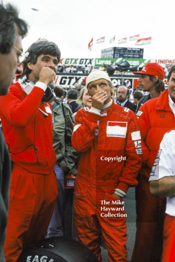 Niki Lauda, Marlboro McLaren MP4, ponders the weather on the grid, British Grand Prix, Silverstone, 1983
