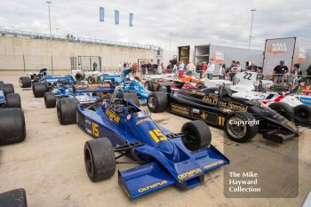 Historic F1 cars in the paddock during the 2016 Silverstone Classic.
