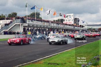 Derek Bell/Peter Hardman, Ferrari 330 LM/B, leaves the grid alongside Nigel Corner, lightweight Jaguar E-type, RAC TT, Goodwood Revival, 1999.
