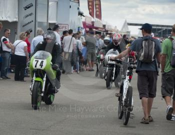 Classic bikes make their way through the paddock, Silverstone Classic, 2010