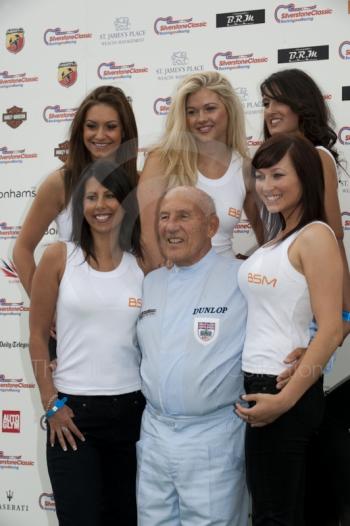 Sir Stirling Moss and BSM girls pose for the cameras, Silverstone Classic 2010