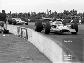 Graham Hill, Lotus 49B, followed by Jackie Stewart, Matra MS80, Silverstone, 1969 British Grand Prix.

