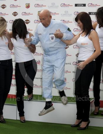 Sir Stirling Moss gets a helping hand from BSM girls, Silverstone Classic 2010