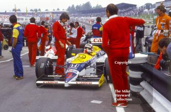 Nigel Mansell, Williams Honda FW11, surrounded by McLaren pit crew, Brands Hatch, 1986 British Grand Prix.
