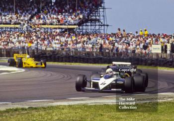 Andrea de Cesaris, Brabham BT56, at Copse Corner before retiring with broken fuel metering unit on lap 28, British Grand Prix, Silverstone, 1987
