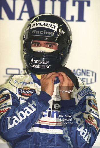 Damon Hill puts on his helmet in the Williams garage, Silverstone, British Grand Prix 1996.
