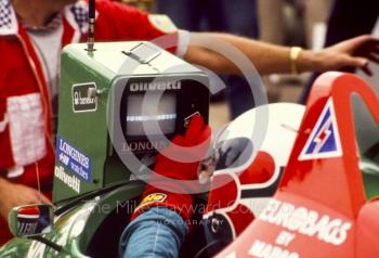 Teo Fabi, Benetton B187, checks lap times in the pits, British Grand Prix, Silverstone, 1987
