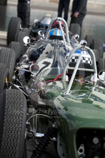 John Chisholm, Lotus 18, follows Nick Wigley, Cooper T51 through the paddock before the HGPCA pre-66 Grand prix cars event, Silverstone Classic 2010