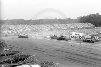 First corner accident with Jacques Laffite's Ligier JS27, hitting the barrier, right, Brands Hatch, British Grand Prix 1986.
