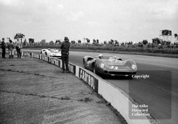 Brian Redman, Lola T70, leads Denny Hulme's Lola T70 at Copse Corner, Silverstone International Trophy sports car race, 1966
