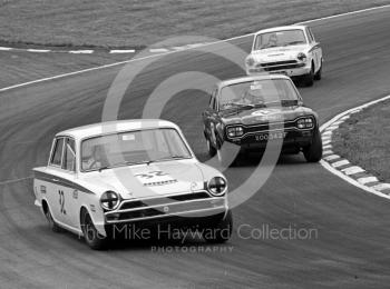 Tony Dean, Lotus Cortina, John Fitzpatrick, Broadspeed Ford Escort, reg no XOO 342F, and Barry Pearson, Lotus Cortina, at South Bank Bend, British Saloon Car Championship race, 1968 Grand Prix meeting, Brands Hatch.
