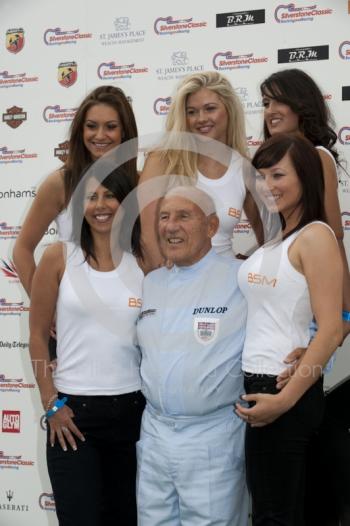 Sir Stirling Moss and BSM girls pose for the cameras, Silverstone Classic 2010